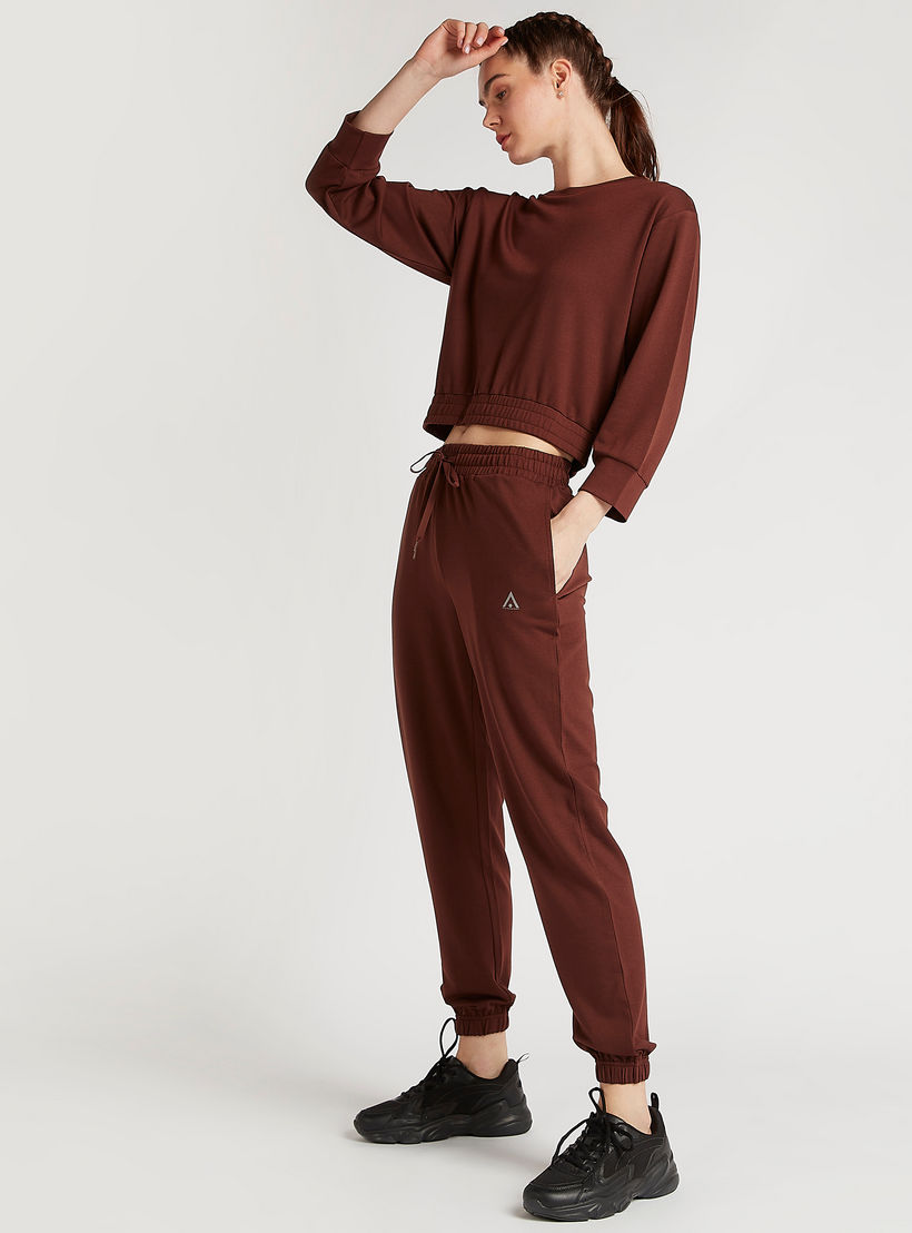 بنطلون رياضي سادة بجيوب وخصر مطّاطي-women-clothing-sportswearandactivewear-bottoms-image-1