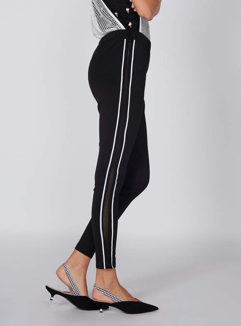 بنطال ليقنز بارتفاع متوسط وخصر مطّاطي وتفاصيل شبكية-women-clothing-bottoms-leggings-image-4