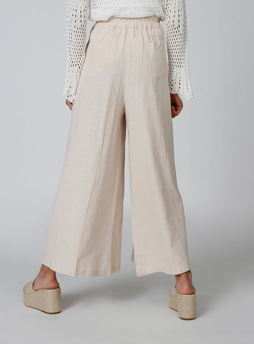 بنطلون بالازو سادة بقصّة واسعة وخصر متوسط الارتفاع وجيوب-women-clothing-bottoms-trousers-image-4
