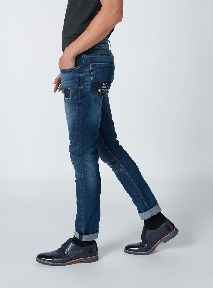 بنطال جينز بتصميم ممزق وجيوب بطبعات من بيينج هيومان-men-clothing-bottoms-jeans-image-4