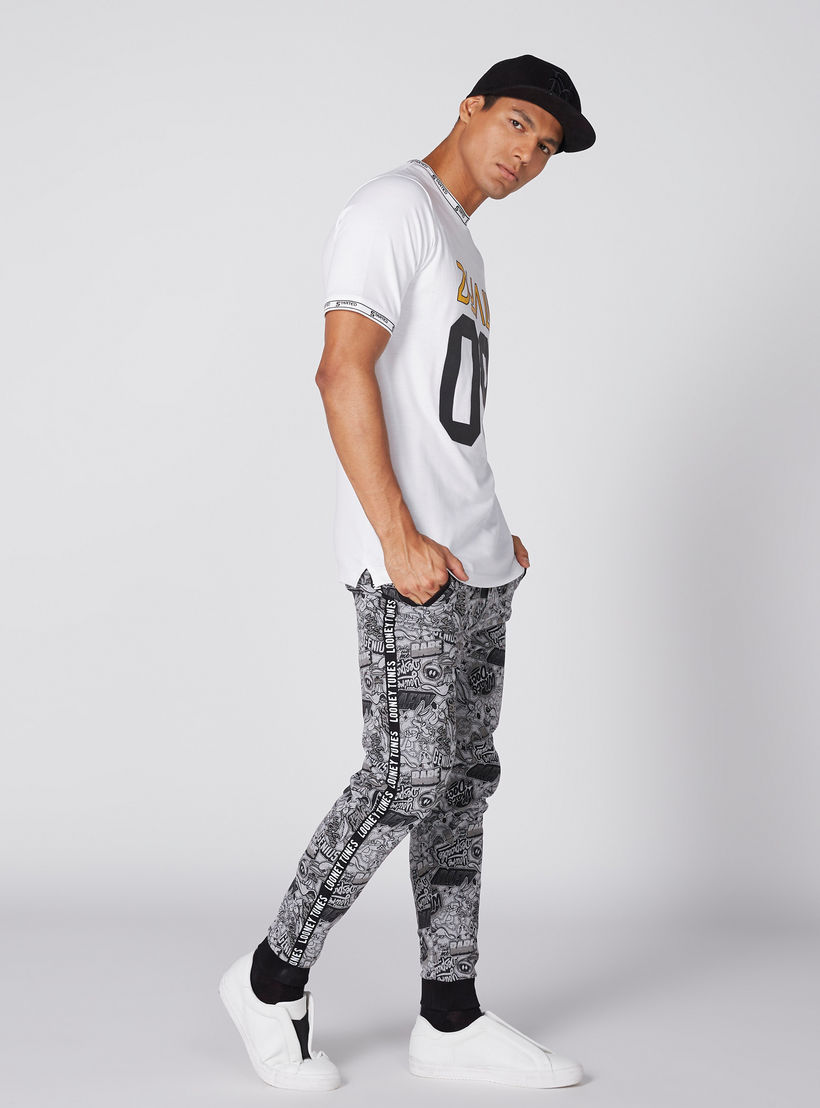 بنطال رياضي بخصر مطّاطي وطبعات لوني تيونز-men-clothing-bottoms-joggers-image-1